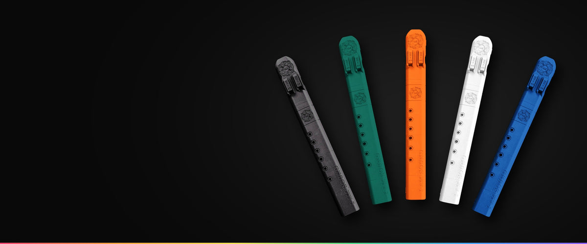 Five IAS F#4 drone flutes fanned out in black, mistletoe green, orange, white and blue on black