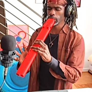 Player with a red drone flute