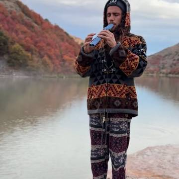Player by a mountain lake